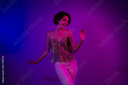 Photo of positive active lady bachelorette celebrate prom party in nightclub dance isolated on ultraviolet neon color background