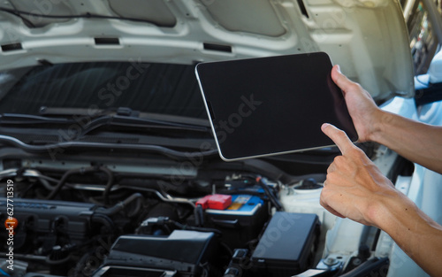 Mechanic using digital tablet Inspecting the Vehicle . Smart Car Service Diagnostics Software concept.