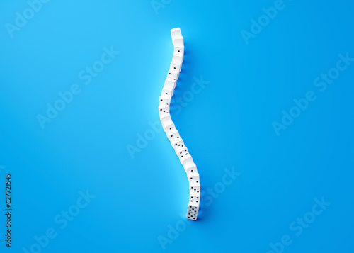 3d Curved Line Of White Domino Tiles Isolated On Blue Background 3d Illustration photo