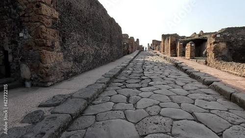 Famous ancient city of Pompeii (Scavi di Pompei) near Naples. Footpath road and ruins in ancient Pompeii, Campania, Italy photo