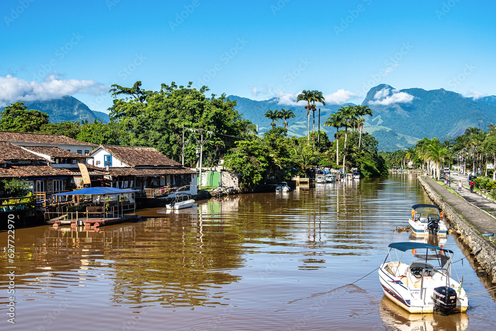Colourful boats moored along the waterfront of Ponte do Pontal at Paraty, Brazil
