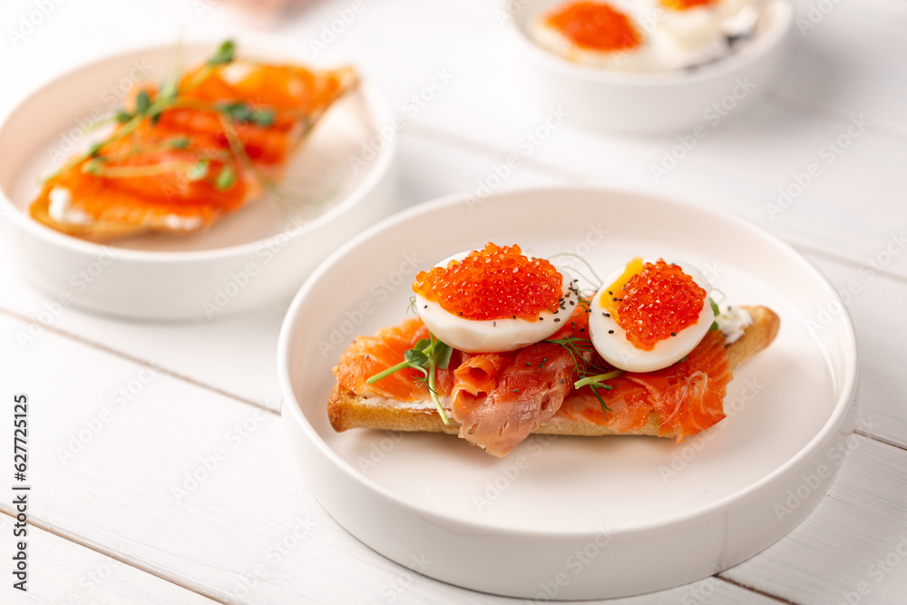 Sandwich with red fish, boiled egg and red caviar Sandwich with red fish, boiled egg and red caviar