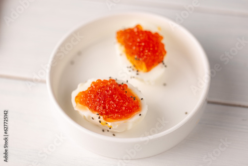 Boiled egg with red caviar