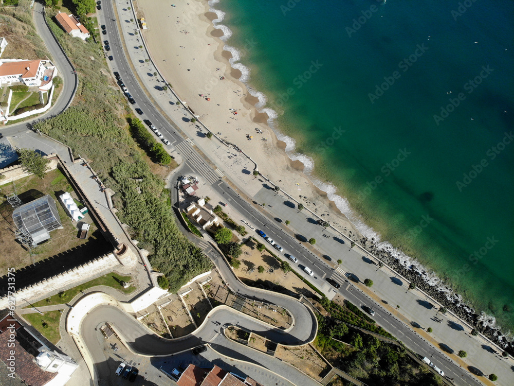 Sines city beach, Portugal. curved road. Aerial drone . Flying over. 