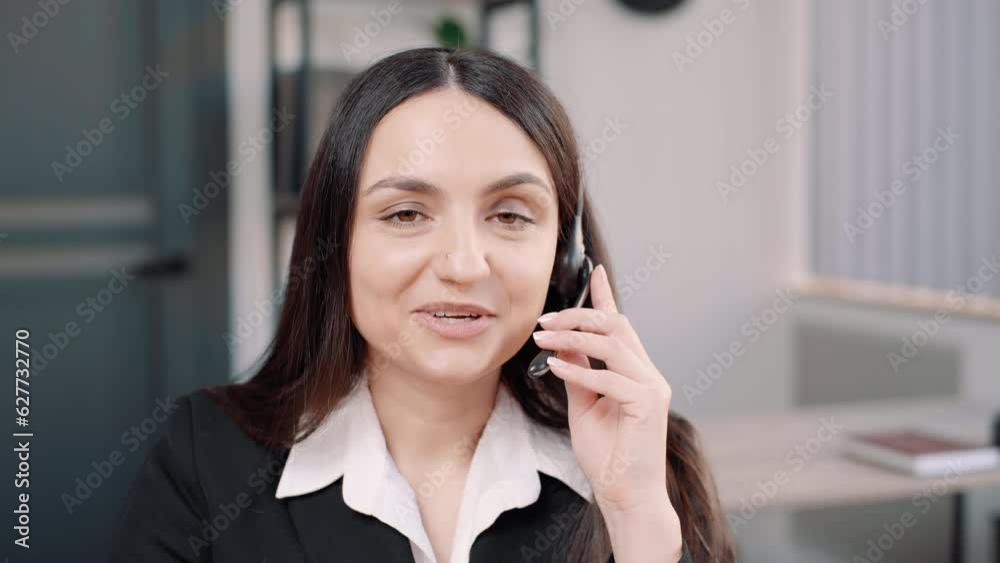 business woman call center working in office workplace. Attractive female employee worker sit on table wearing headset and use laptop computer talk to support customer in company. Looking at camera business woman call center working in office workplace. Attractive female employee worker sit on table wearing headset and use laptop computer talk to support customer in company. Looking at camera