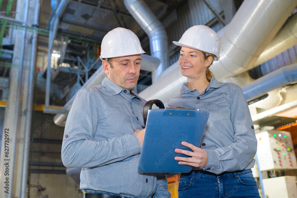 female and male engineer checking pipeline connections