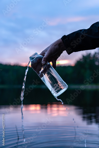 Getting fresh drinking water from Scandinavian lake © mitevisuals