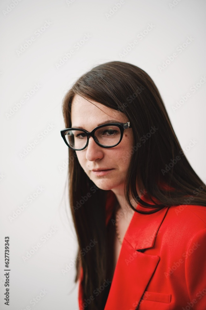 portrait of a business woman in a red suit looking away portrait of a business woman in a red suit looking away