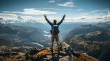 A man holds his arms open in success after hiking to the top of a mountain. 