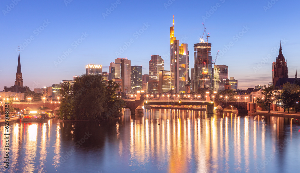 Skyscrapers in Frankfurt am Main against the backdrop of the river at sunset.