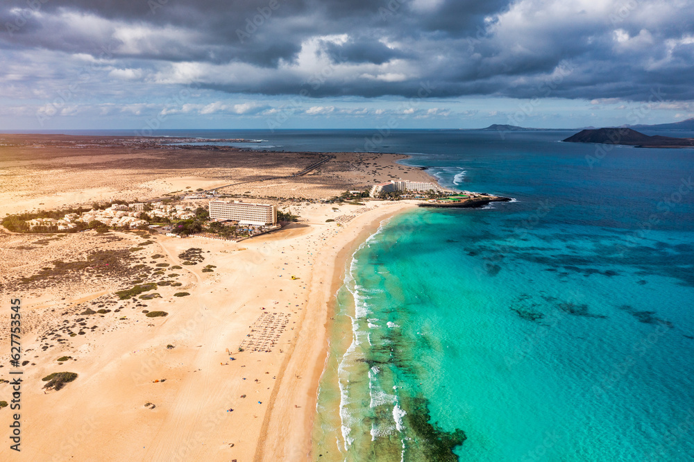 Aerial view of beach in Corralejo Park, Fuerteventura, Canary Islands. Corralejo Beach (Grandes Playas de Corralejo) on Fuerteventura, Canary Islands, Spain. Beautiful turquoise water and white sand.