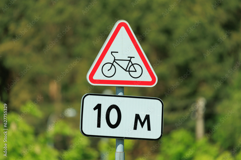 Information board or road sign for cyclists on the street on a summer day Information board or road sign for cyclists on the street on a summer day