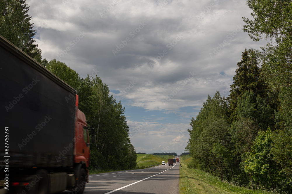 Cars, truck and highway road in the countryside