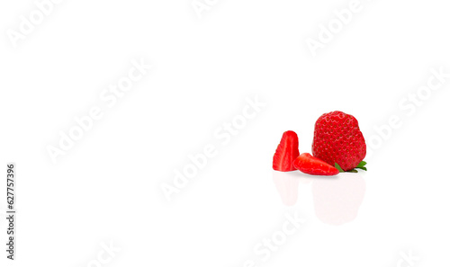 One whole Red ripe strawberries cut into pieces on a white background 