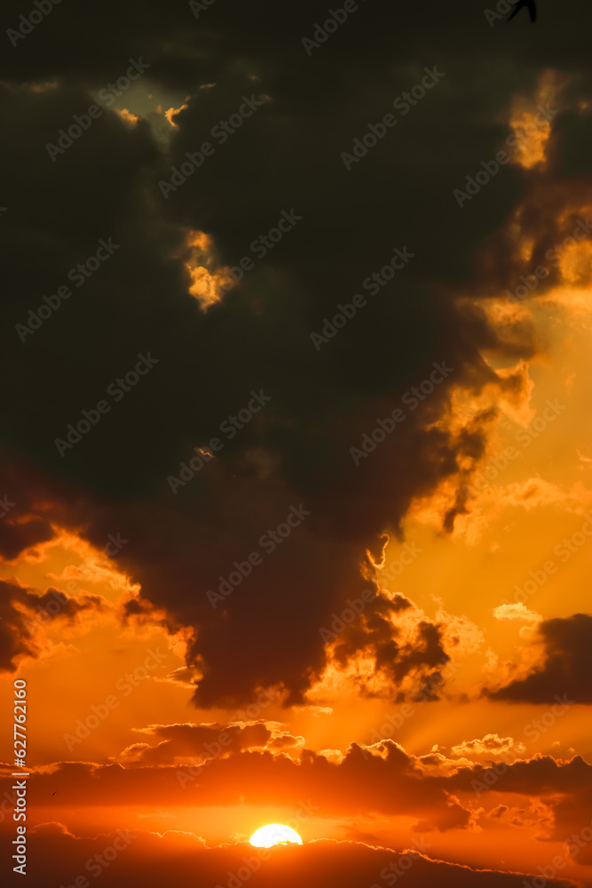  A cloudy landscape sunset in the shape of a red heart. Love and separation concept
