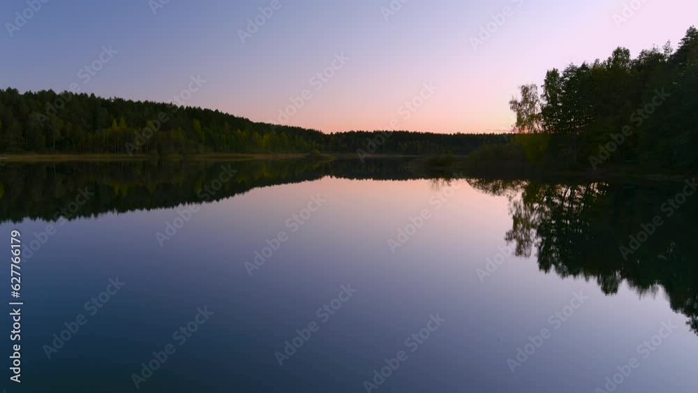 Aerial evening view of beautiful smooth waters of a lake and a sunset sky Aerial evening view of beautiful smooth waters of a lake and a sunset sky
