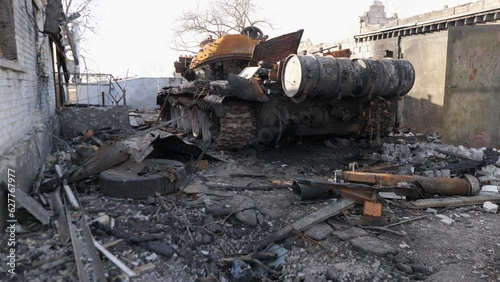 Destroyed houses after bomb attacks in Ukraine. Burned tank. Ukraine war. Velyka Dymerka, Kyiv oblast. photo