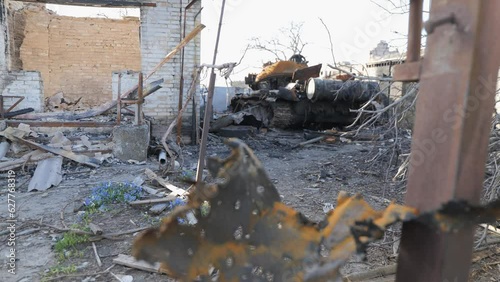 Destroyed houses after bomb attacks in Ukraine. Burned tank. Ukraine war. Velyka Dymerka, Kyiv oblast. photo