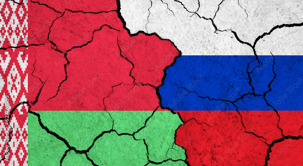 Flags of Belarus and Russia on cracked surface - politics, relationship concept
