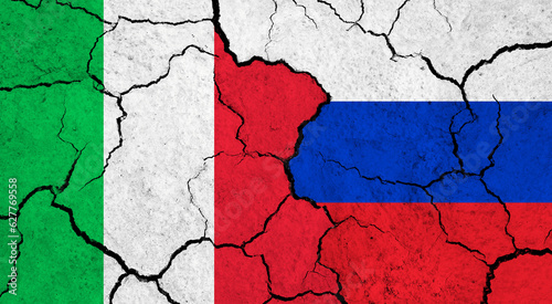 Flags of Italy and Russia on cracked surface - politics, relationship concept