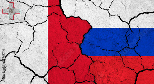 Flags of Malta and Russia on cracked surface - politics, relationship concept