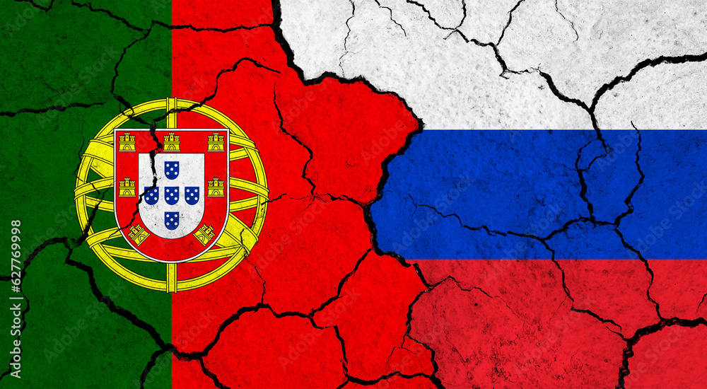 Flags of Portugal and Russia on cracked surface - politics, relationship concept