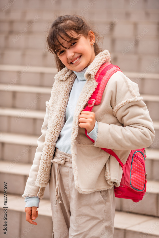 A portrait of a happy girl student with school backpack outside. A portrait of a happy girl student with school backpack outside.