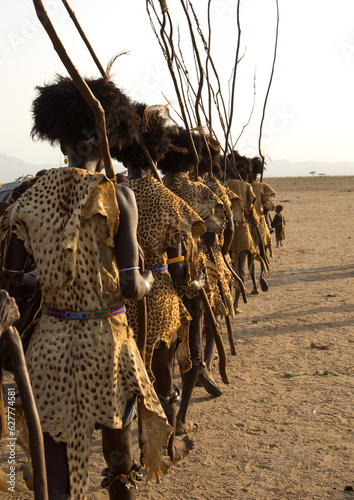 Dassanech men with leopard skins and ostrich feathers wigs during Dimi ceremony to celebrate circumcision of teenagers, Turkana County, Omorate, Kenya photo