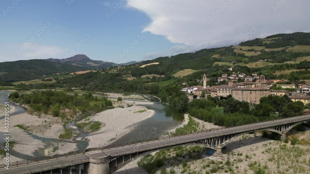Europe, Italy , Emilia Romagna , drone aerial view of Travo village with bridge on the river in Val Trebbia Bobbio - drought and aridity during summer water emergency - Climate change global warming Europe, Italy , Emilia Romagna , drone aerial view of Travo village with bridge on the river in Val Trebbia Bobbio - drought and aridity during summer water emergency - Climate change global warming