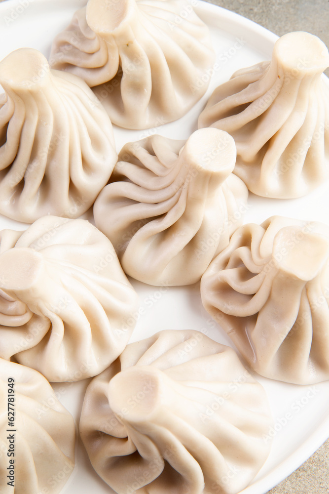 Khinkali traditional dish. On a light background. Selective focus. Khinkali traditional dish. On a light background. Selective focus.