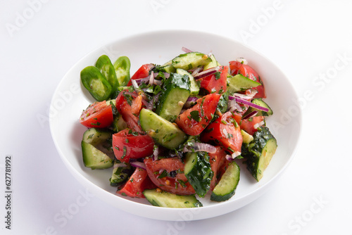 Salad of fresh cucumbers and tomatoes in a plate. selective focus.