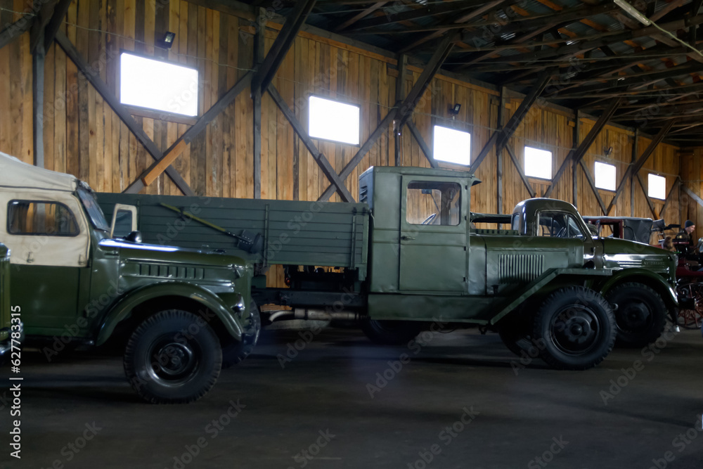 Military russian green army vehicle standing in the hangar. The military vehicle support Ukraine. War russia. Out of focus