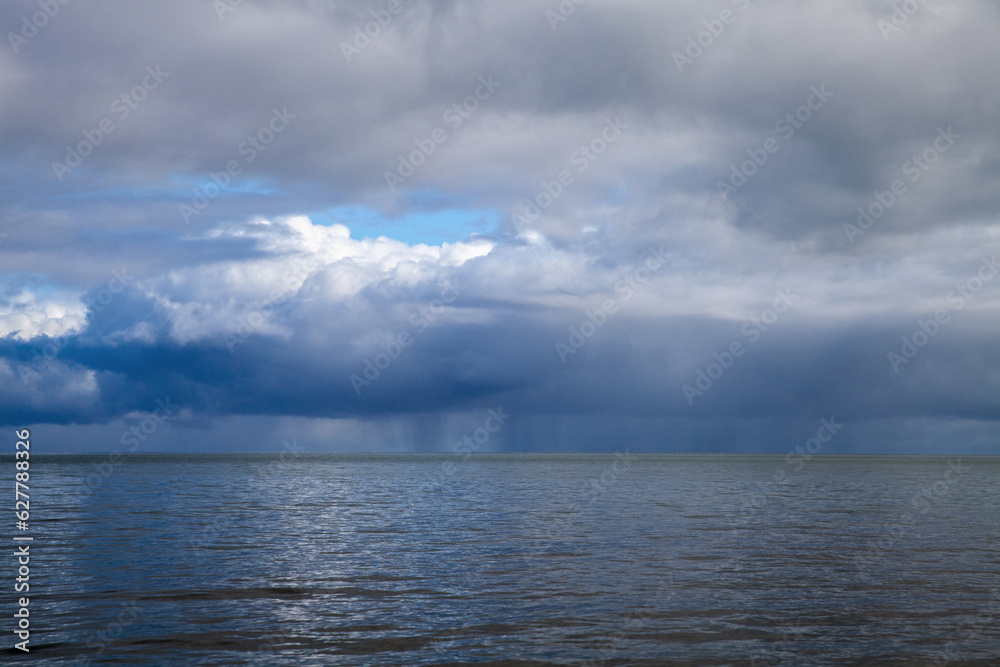Stormy sky with rain over the ocean, natural background Stormy sky with rain over the ocean, natural background
