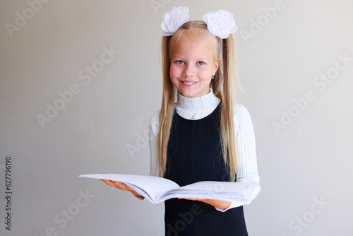 Smiling school girl hold the book  photo