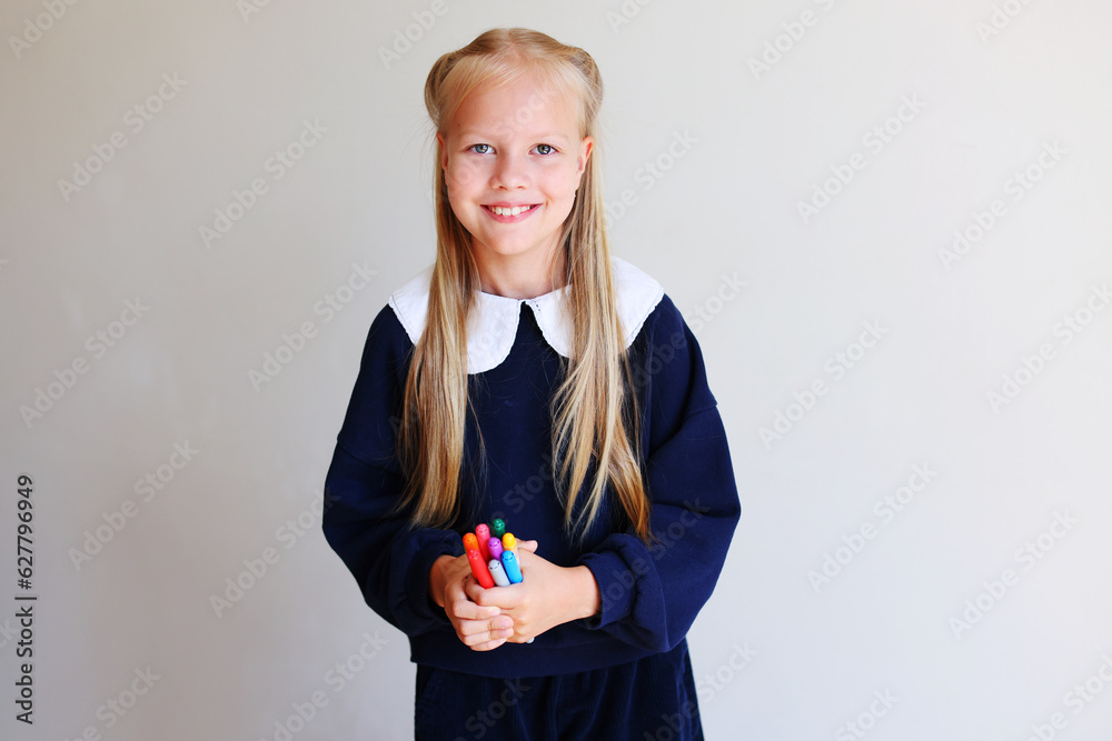 Beautiful cute school girl with glasses holding colorful pencils. Sulky child with pencils. Imagination and creativity at school concept. Beautiful cute school girl with glasses holding colorful pencils. Sulky child with pencils. Imagination and creativity at school concept.