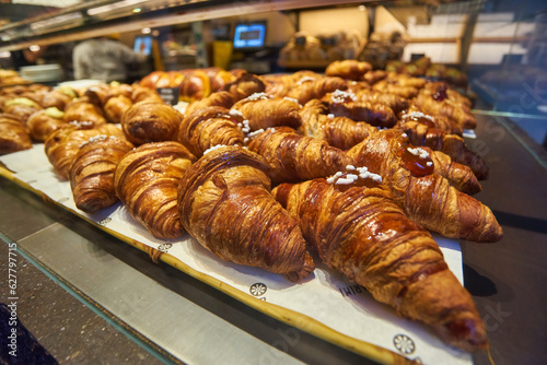 Assortment of freshly baked croissants for sale on counter of shop, market, cafe or bakery. Dessert, pastry, breakfast, sweet food and traditional french cuisine