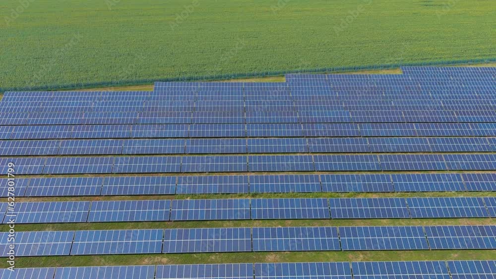 Top view of a solar power plant in the countryside (camera moves backwards). Alternative green energy Top view of a solar power plant in the countryside (camera moves backwards). Alternative green energy