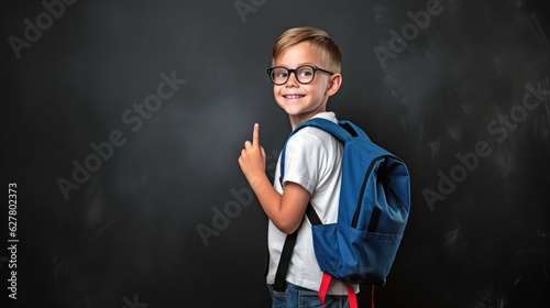 Ready to Learn: Child Standing by Blackboard with Backpack © Exotic Escape