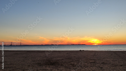 Atardecer en la playa de Valdelagrana (Cádiz, España). Puesta de sol  photo