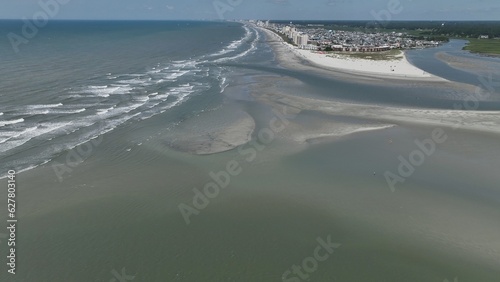 Vast sandbar at North end of Cherry Grove Beach where people sunbath on beautiful beach while on summer vacation at North Myrtle Beach in South Carolina
