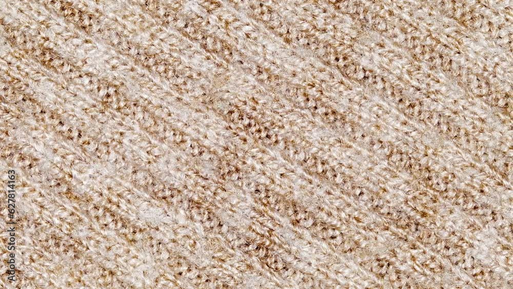 Beige knitted fabric close-up with diagonal seams, moving sideways, close-up macro, top view, uniform texture background
Beige knitted fabric close-up with diagonal seams, moving sideways, close-up macro, top view, uniform texture background