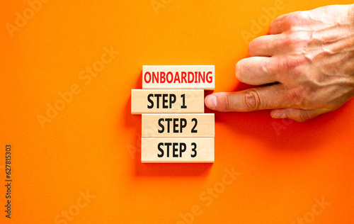 Time to step 1 onboarding symbol. Concept words Onboarding step 1 on wooden block. Businessman hand. Beautiful orange table orange background. Business success step 1 onboarding concept. Copy space.