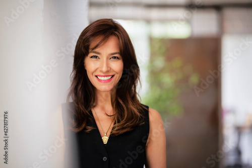 Close-up of an attractive mid aged woman cheerful smiling and standing at the wall Free Download Close-up of an attractive mid aged woman cheerful smiling and standing at the wall - GFXLoad