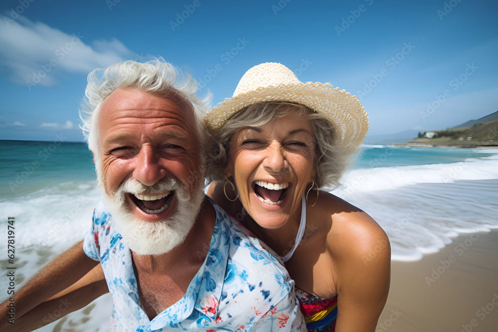 Senior happy man and woman walking on the beach