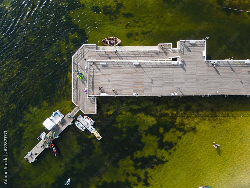 Fototapeta premium molo pier of Polish village Jastarnia, water of Baltic Sea, aerial drone view