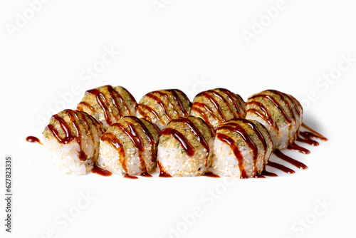 Rolls topped with sauce. Delicious Asian food, rolls, sushi. Separate on a white background. Culinary dish for restaurant menu