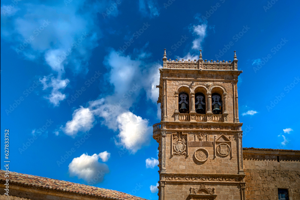 Horizontal view of the beautiful plateresque tower of the church of Morón de Almazan, in Soria, Spain, with intense blue sky in the background