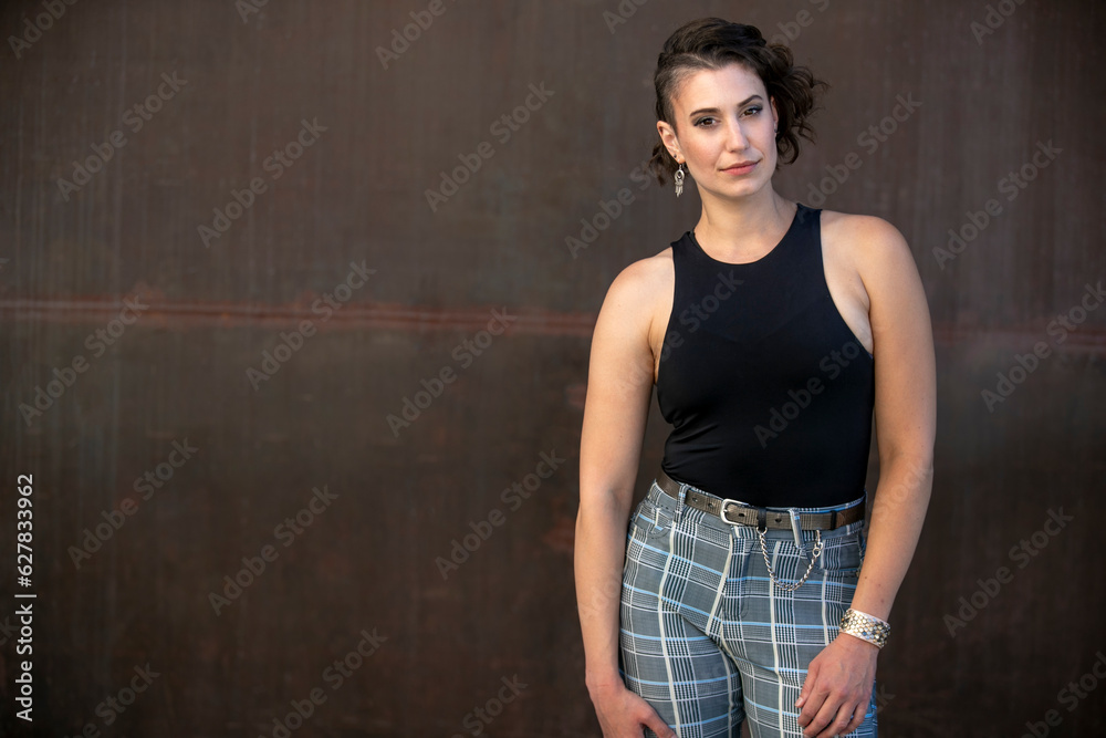 Fototapeta premium Serious portrait of a stylish woman with interesting hair style, lgbtq lifestyle 