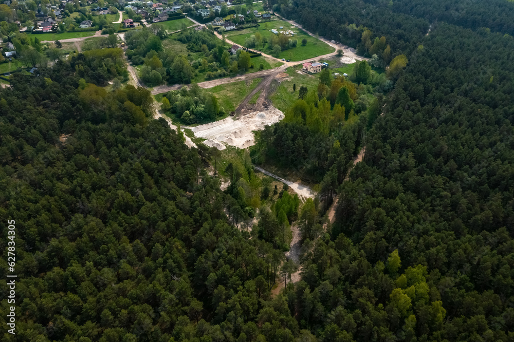 Top drone view of construction site near forest. White sand. Nature of Jurmala. Small town.