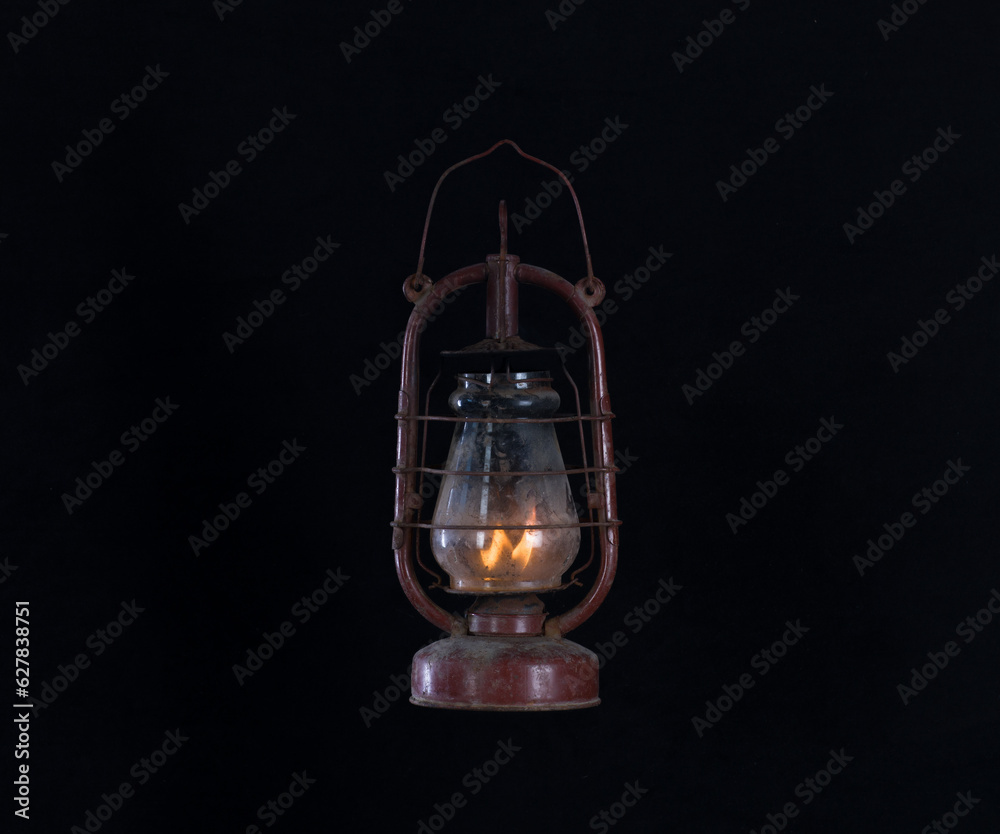 rusty dirty kerosene lamp isolated on black background